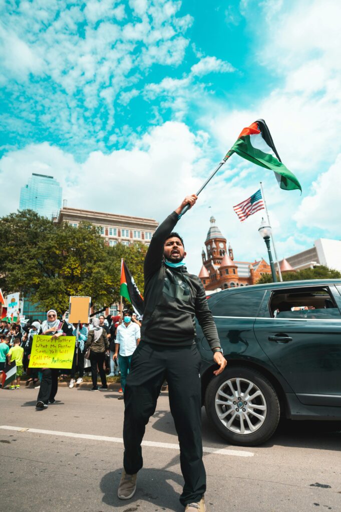 A passionate demonstration featuring Palestinian flags and diverse participants, capturing the spirit of activism.